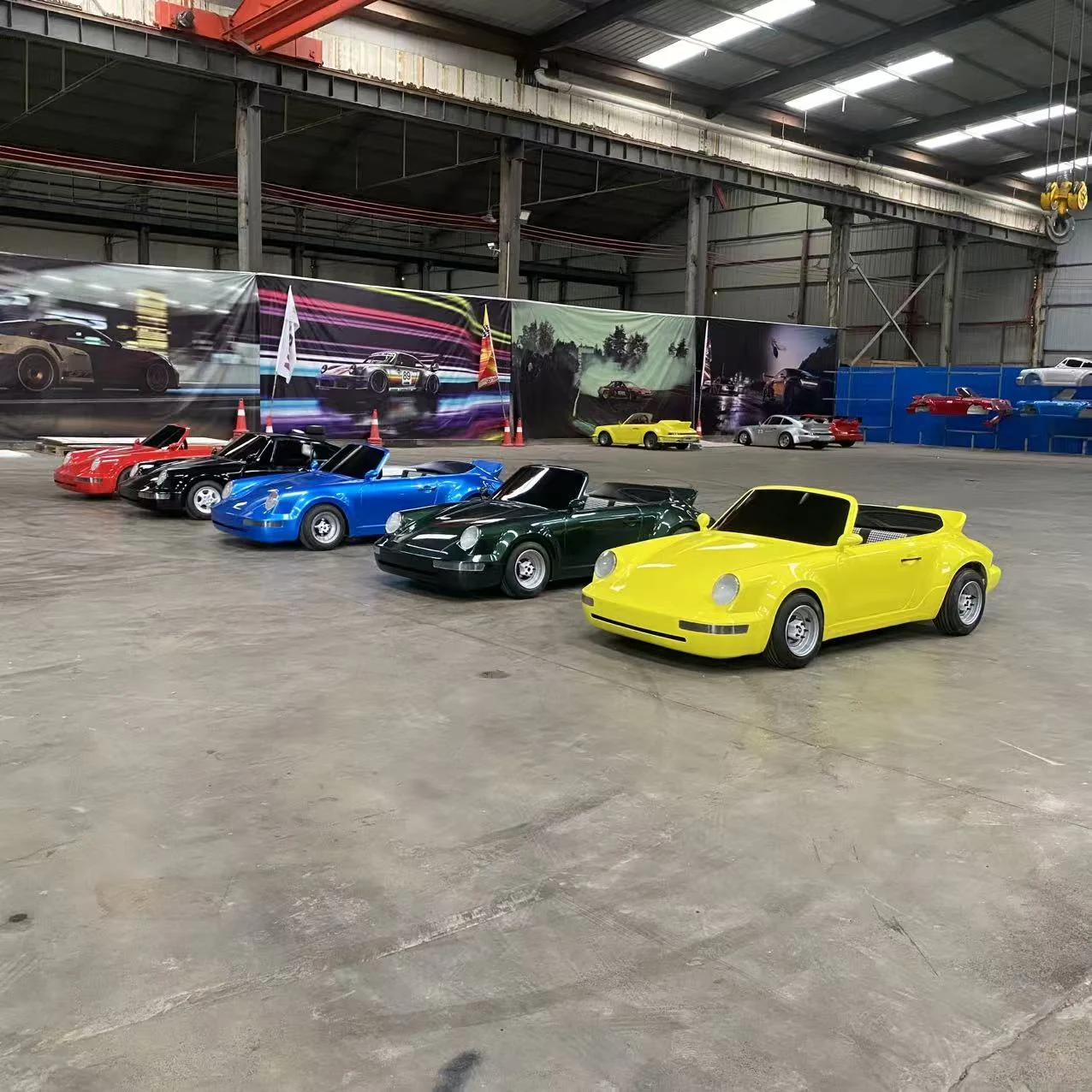 A row of yellow, green, blue, black and red open-top adult drift go karts