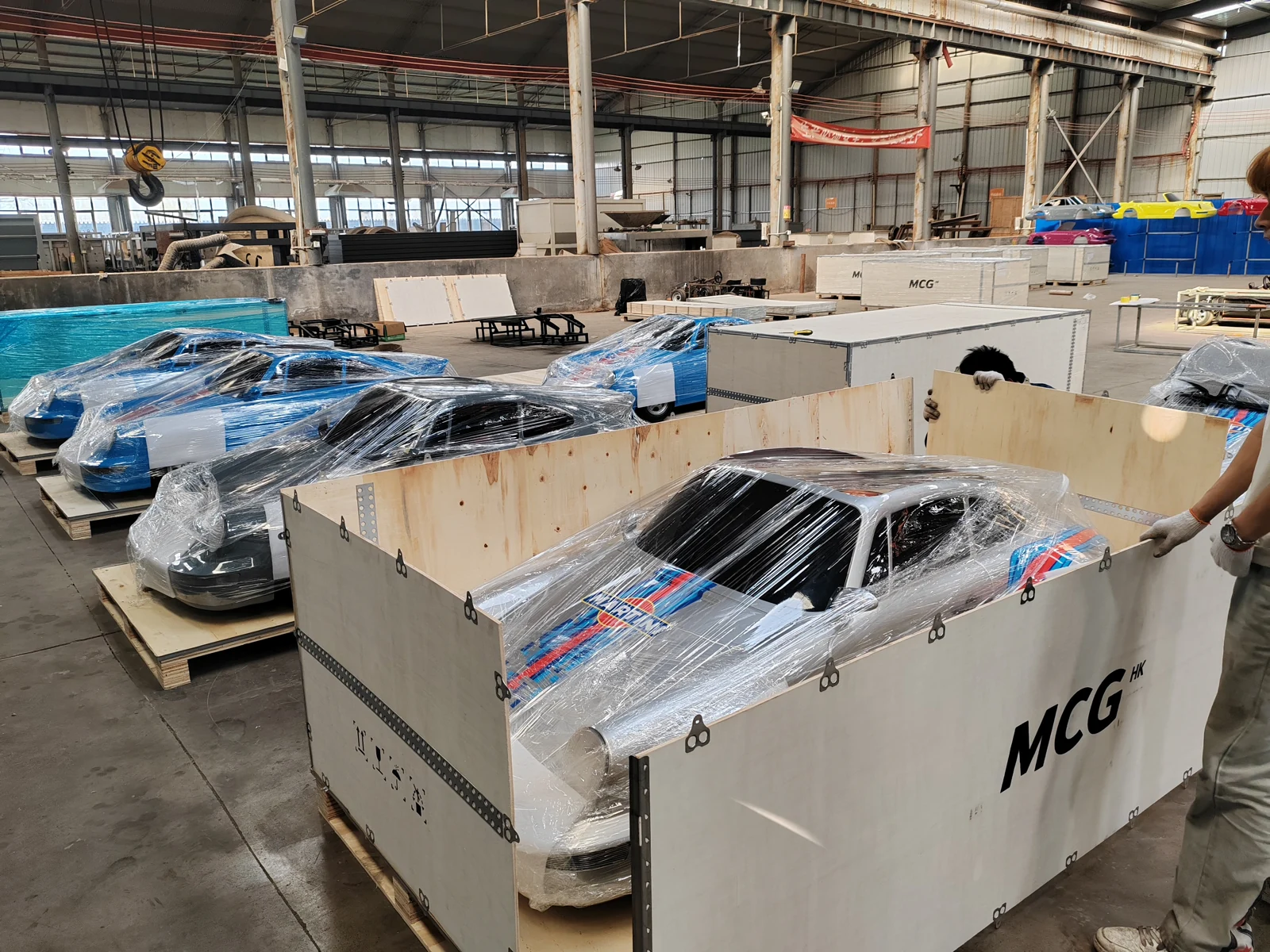 Adult drift go karts with protective wrapping being packed into wooden shipping crates