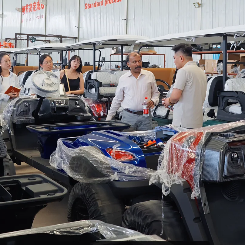 International buyers reviewing electric golf cart models during a factory tour